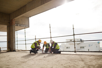 Construction workers working at highrise construction site
