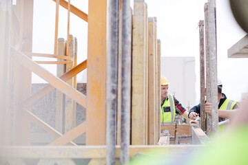Construction worker engineer digital tablet talking at construction site