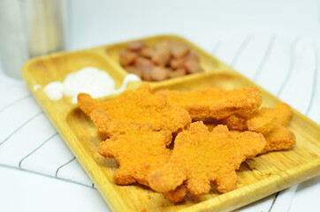 Chicken nuggets and sausage with mayonaise, studio shot with a white background