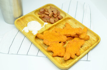 Chicken nuggets and sausage with mayonaise, studio shot with a white background