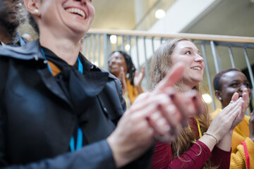 Smiling audience clapping