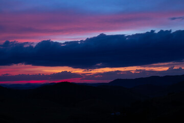 sunset, mountains, valleys, landscape, golden hour, orange sky.
blue and orange sky
