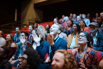 Smiling, excited audience cheering