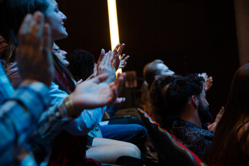 Smiling audience clapping