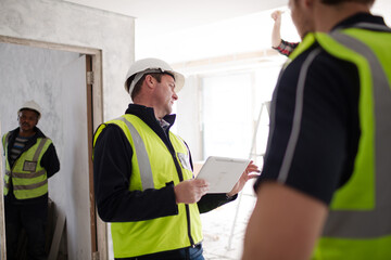 Foreman with digital tablet at construction site