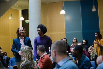 Conference audience watching speakers on stage