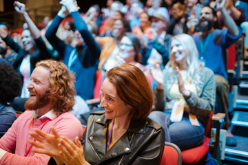 Smiling, excited audience cheering