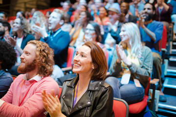 Smiling, excited audience cheering
