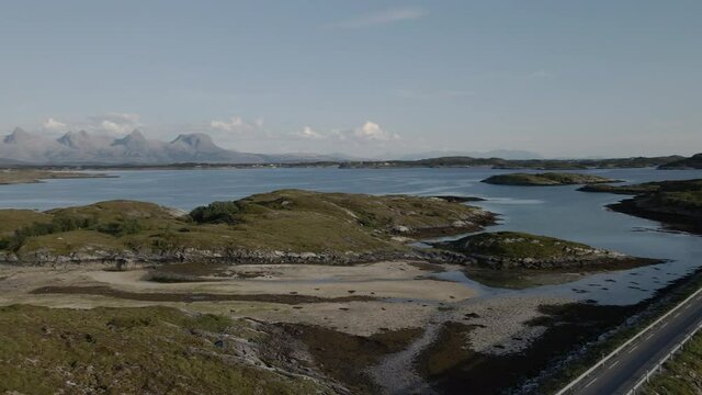 Country Road Connecting Small Islands In The Sea, Heroy, Nordland, Norway - aerial orbit