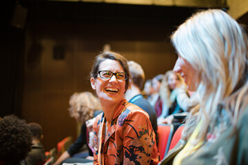 Businesswomen talking in conference audience