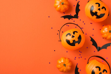 Top view photo of halloween decorations pumpkin baskets bat silhouettes and violet sequins on...
