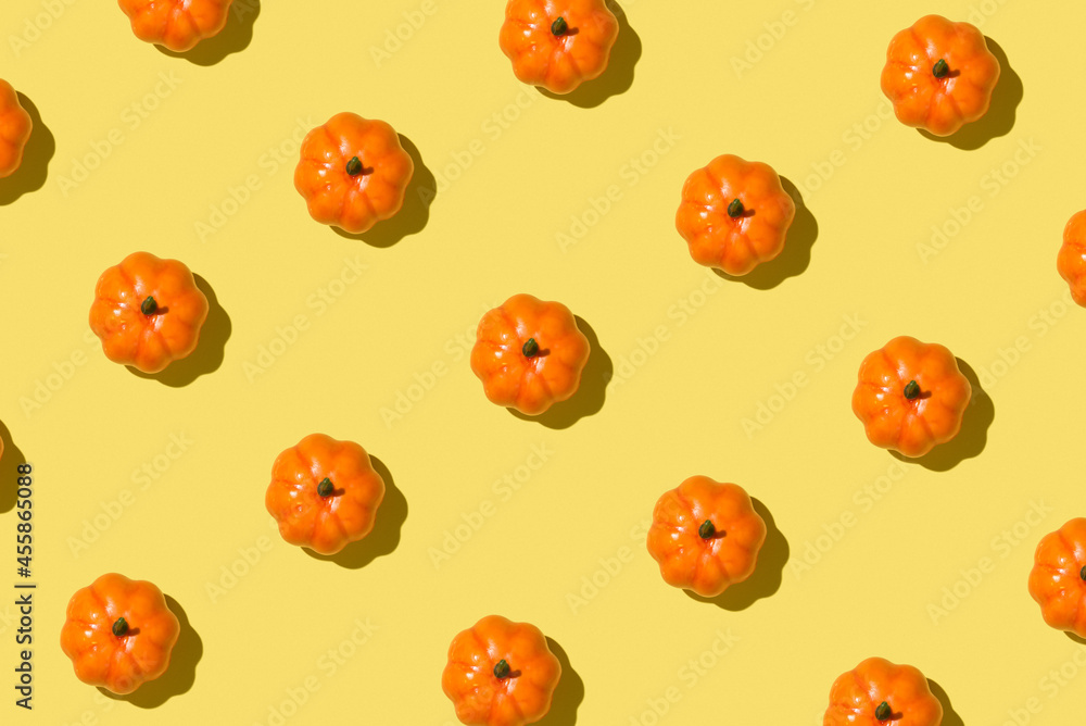 Poster Photo of orange pumpkins on isolated yellow background