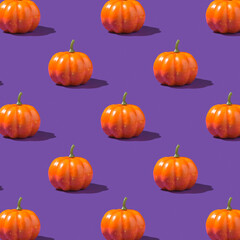 Photo of orange pumpkins on isolated violet background