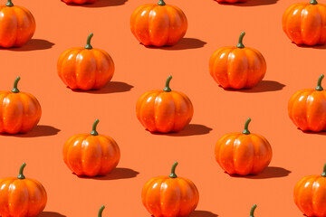 Photo of orange pumpkins on isolated bright color orange background