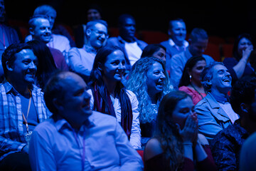 Happy audience in dark room