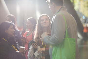 People talking in hall of auditorium