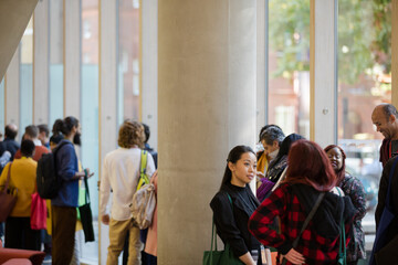 People talking in hall of auditorium