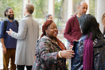 Two women greeting in hallway