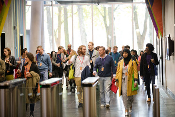 People entering auditorium hallway