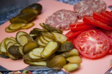 Cutlets of fresh minced meat, pickles, tomatoes on the table.