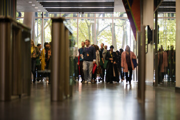 People entering auditorium hallway