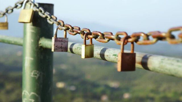 Padlocks on a rusty chain on the viewpoint Kaiser's Throne in the town of Pelekas on the Island of Corfu Greece