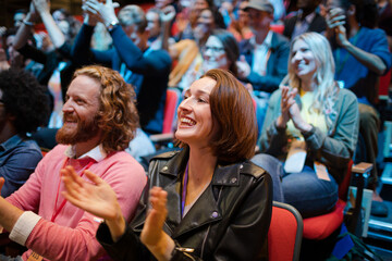 Smiling, excited audience cheering