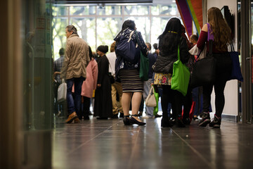 People talking in hall of auditorium