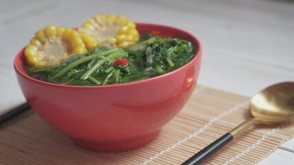 Known as Sayur bening bayam. Indonesian food of spinach with soup and corn