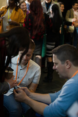 Business people using smart phone in conference audience