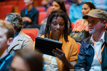 Business people talking in conference audience