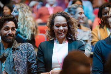 Audience watching speakers on stage