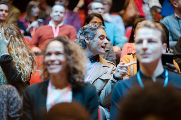 Audience watching speakers on stage