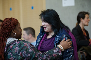 Two women greeting in hallway