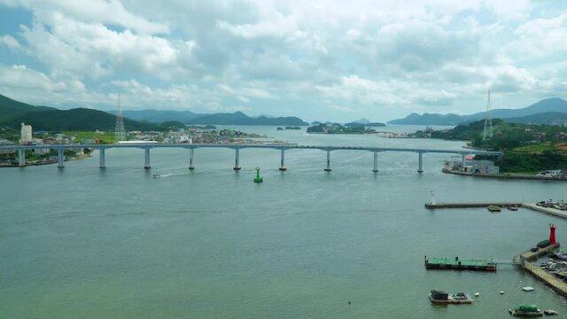 Geoje Bridge Over Calm Sea With White Clouds In The Sky In South Korea. - wide shot