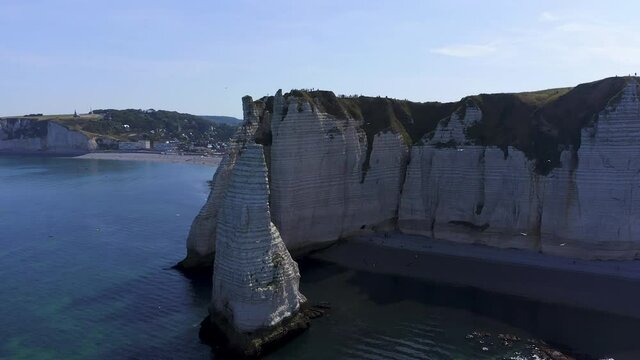 Warpspeed Effect. Aerial speedramp circle shot starting lockdown of a chalk rock revealing the village of Etretat France Normandy on a sunny day