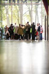 People talking in hall of auditorium