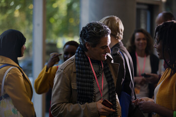 People talking in hall of auditorium