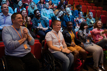 Smiling, happy audience clapping