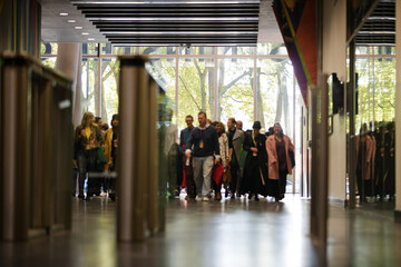 People entering auditorium hallway