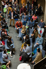 Conference audience watching speakers on stage