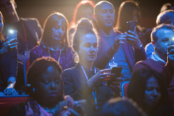 Audience clapping and cheering in dark concert hall