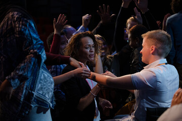 Audience reaching for and talking with speakers