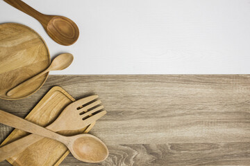 wooden kitchen utensils on wooden and white background
