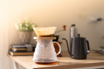 Naklejka na ściany i meble Drip coffee with moka pot on wooden table in the morning