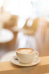 cup of coffee on wooden table