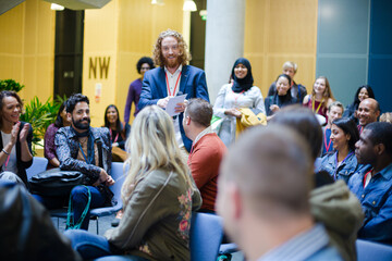 Male speaker on stage talking to audience