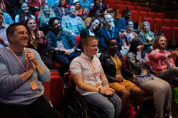 Smiling, happy audience clapping