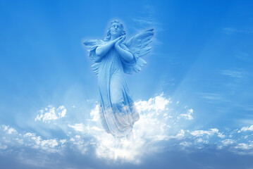 Angel sculpture on blue sky background - 455873648