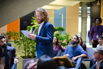 Male speaker on stage talking to audience